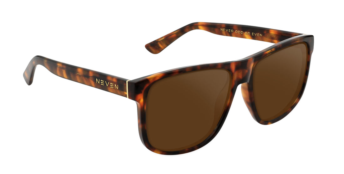 Three-quarter view of Ember prescription sunglasses, large tortoiseshell gloss frame with gold temple logo and brown lenses
