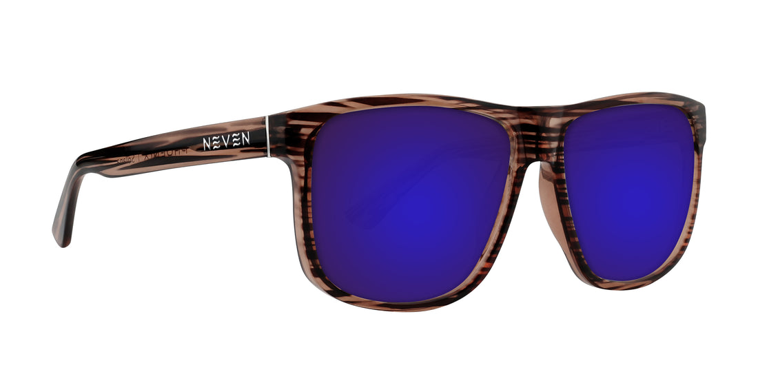 Three-quarter close-up of Solana prescription sunglasses showcasing transparent wood grain glossy frame and purple mirrored lenses on white background
