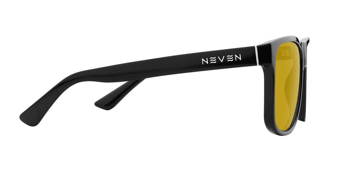 Side view of Triumph sunglasses showing glossy black temple with NEVEN logo, silver hinge and yellow lens on white background