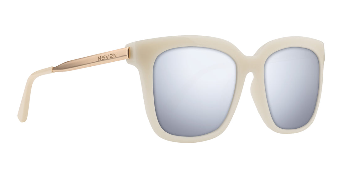 Right-front close-up of Sand Dollar sunglasses with milky greige frames and gold engraved arms, silver prescription lenses
