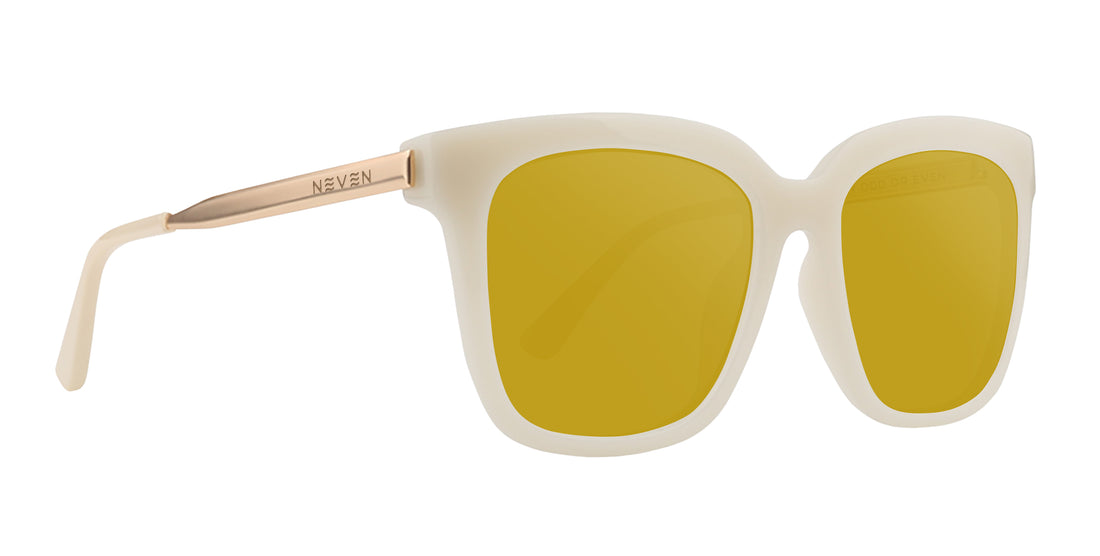 Close-up of Sand Dollar sunglasses with milky white greige frames, gold engraved arms and yellow lenses on white background