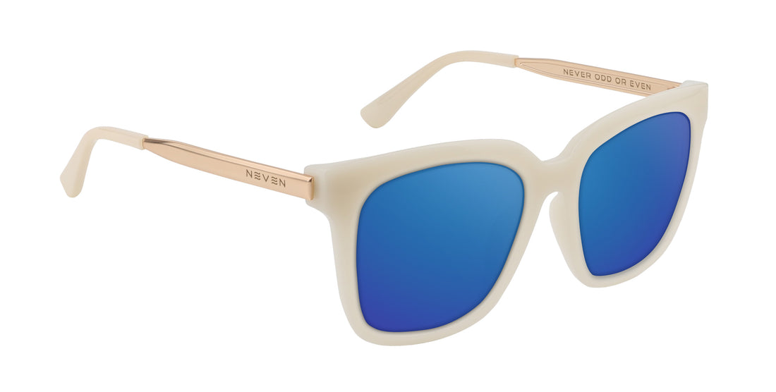 Three-quarter view of Sand Dollar sunglasses with white-greige square frame, gold engraved arms, and blue mirrored lenses