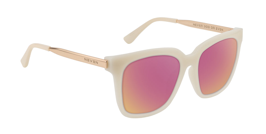 Angled close up of Sand Dollar sunglasses with cream greige frame, rose pink mirrored lenses and gold arms engraved NEVEN