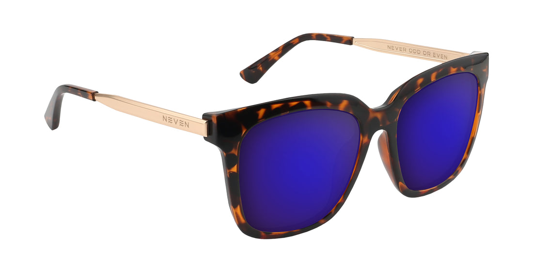 Three-quarter view of Sarasota prescription sunglasses showcasing glossy tortoise shell frame, purple lenses, and gold engraved temples on white