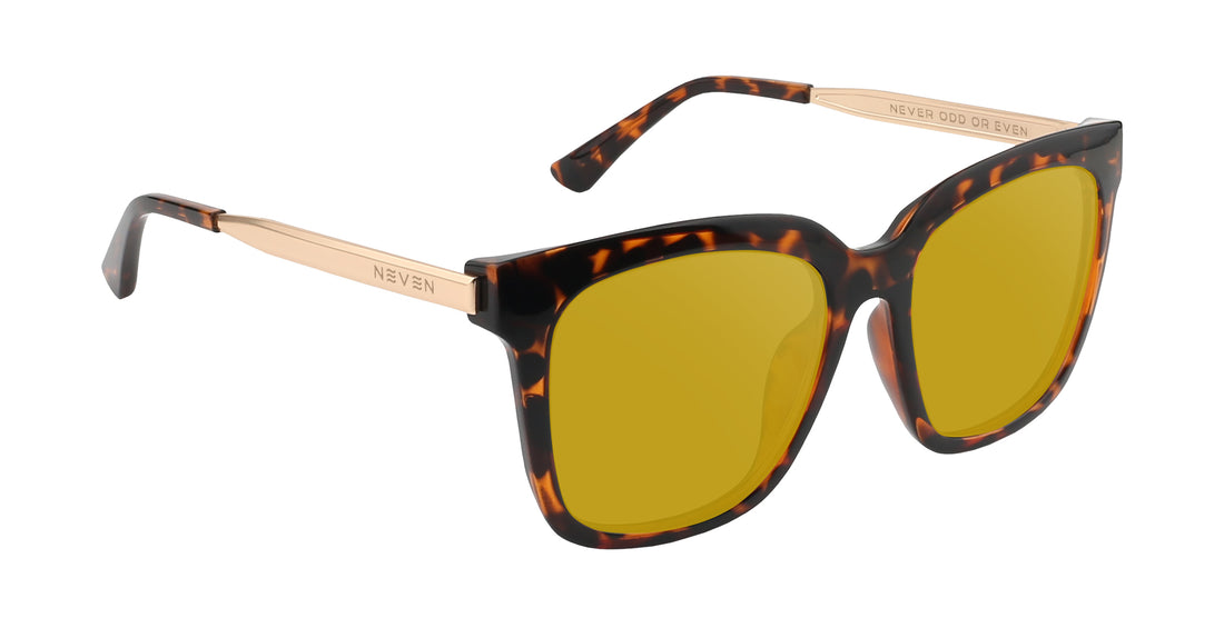 Three-quarter view of Sarasota sunglasses showcasing tortoise shell frame, yellow lenses, and engraved gold temples on white background