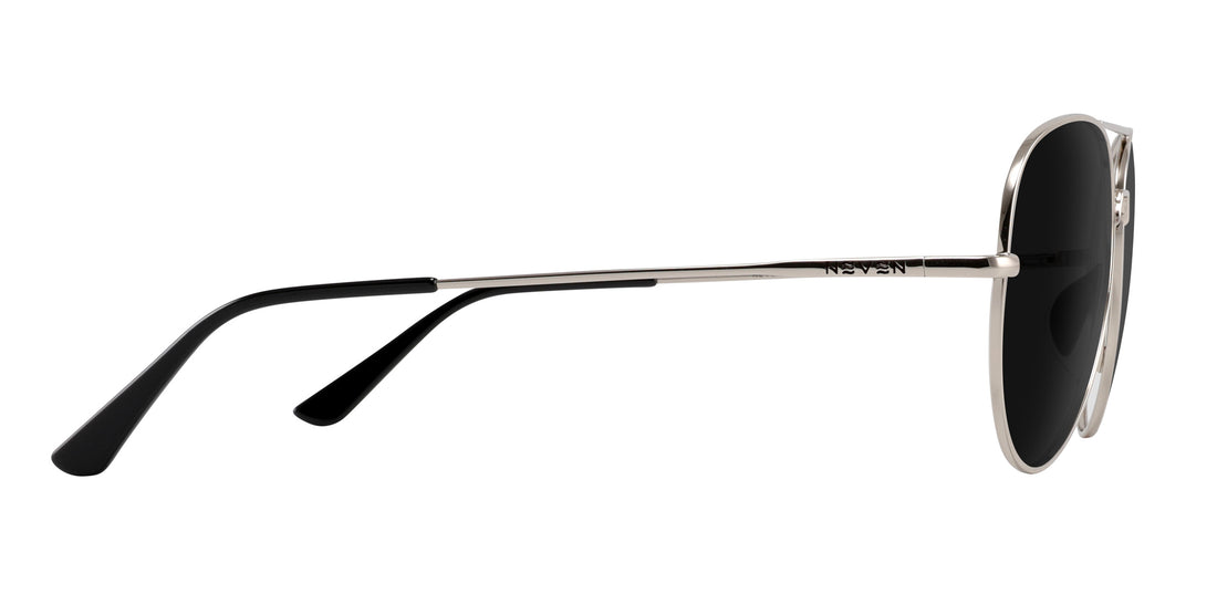 Side view of Shirogane Rx sunglasses showcasing silver metal frame and slim temples with black tips on white background