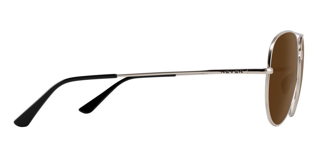 Side view of Shirogane sunglasses showing slim polished silver metal frame, brown lenses, and black temple tips on white background