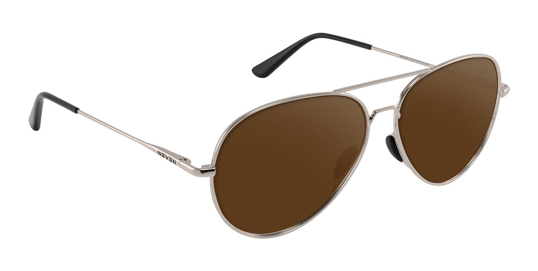 Angled close up of Shirogane prescription aviator sunglasses with polished silver frames and brown lenses on white