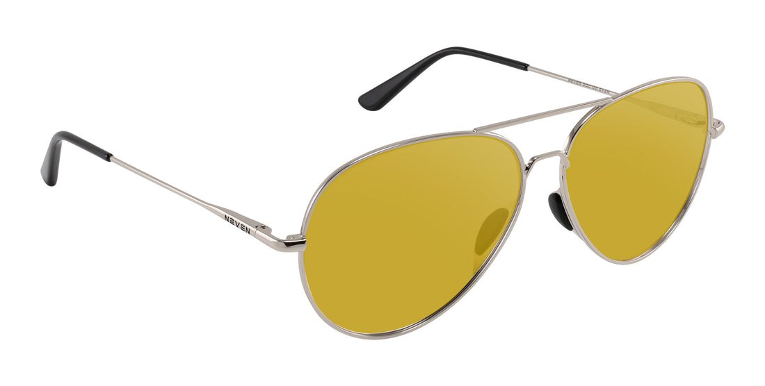 Angled close-up of Shirogane sunglasses showcasing silver metal frame and yellow lenses on white background