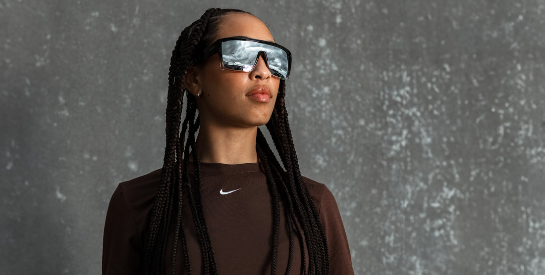 Model wearing Inlet black rectangular polarized sunglasses, looking upward against a mottled gray studio backdrop
