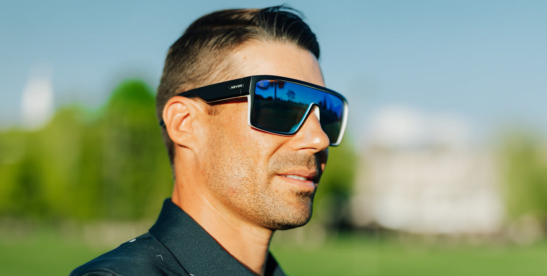 Man wearing black and white Spanish House polarized sunglasses with blue lenses outdoors