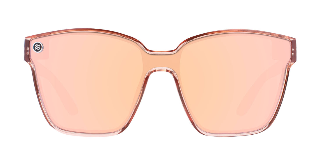 Front close-up of Spirit sunglasses showing transparent pink cat-eye frame and polarized pink lenses on white background