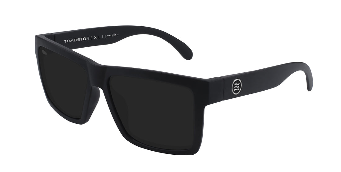 Three-quarter view of Lowrider XL sunglasses with black TR90 frame, polarized lenses and metal logo on white background