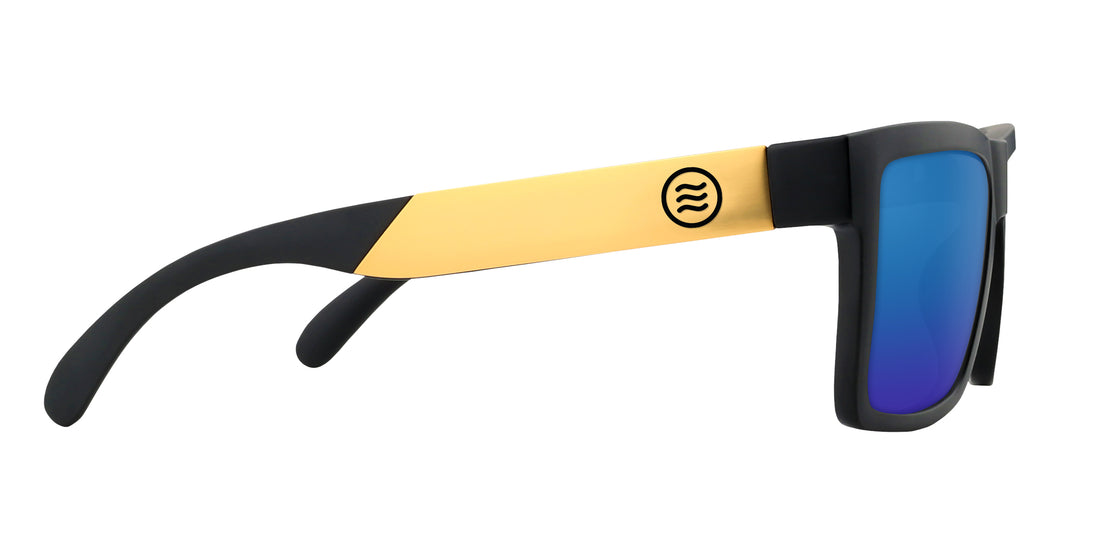 Side view of Prospector XL sunglasses showing black matte frame, gold metal temple with logo, and blue mirrored lens