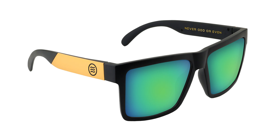 Three-quarter view of Prospector XL sunglasses with matte black frame, gold temples and green mirrored lenses on white