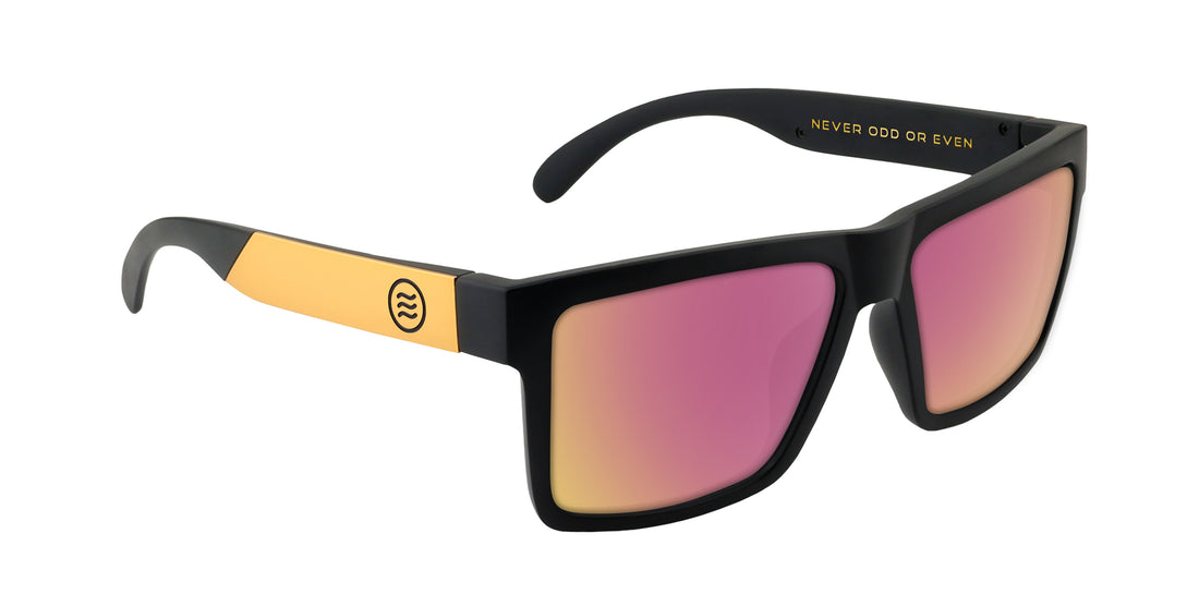 Angled right view of Prospector XL sunglasses showing black matte frame, gold temples and pink mirrored lenses on white