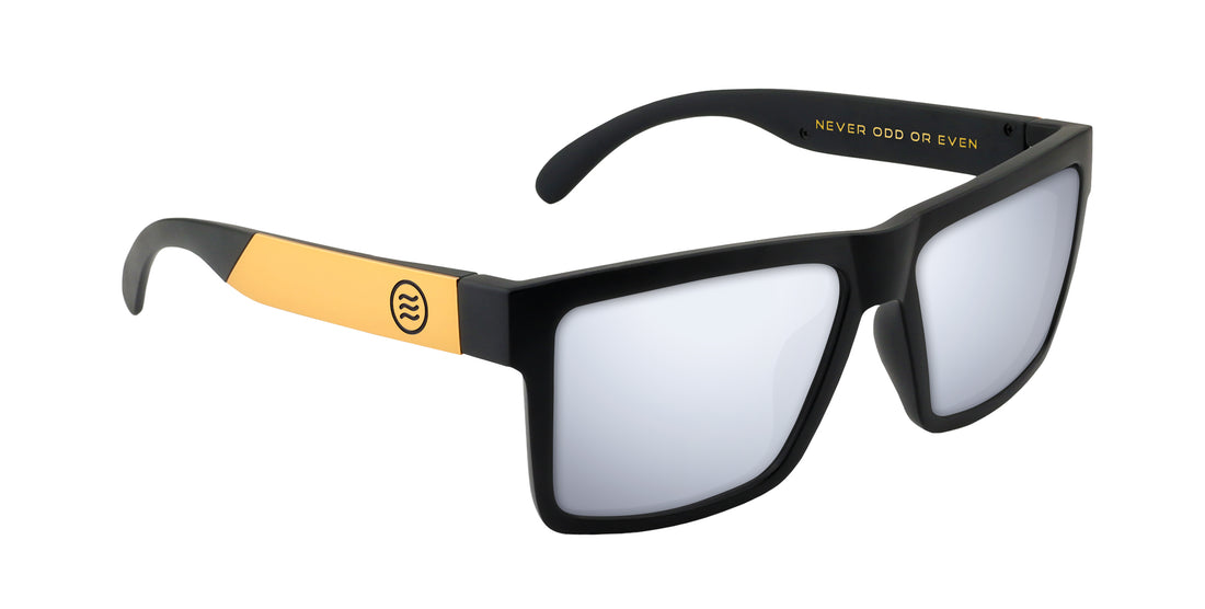 Three-quarter view of Prospector XL sunglasses with matte black frame, gold temples and mirrored lenses on white background