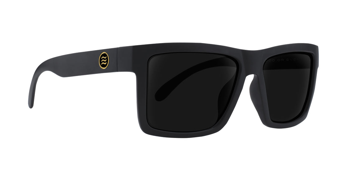 Angled close up of Sentry XL sunglasses showcasing matte black X Large frame, gold logo on temple and dark prescription lenses on white background