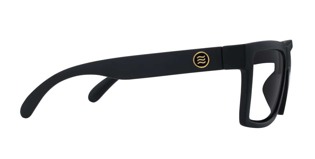 Side view of Sentry XL sunglasses showcasing matte black XL frame and gold round logo on temple with white background