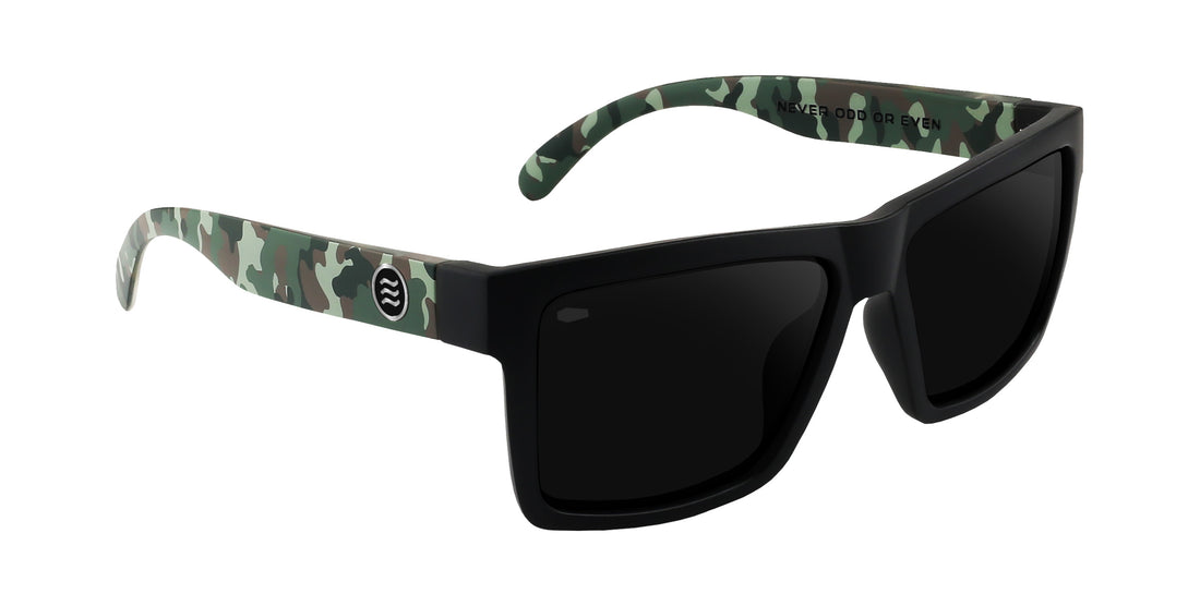 Three-quarter view of Bad Company sunglasses with black frame, black polarized lenses, and camo arms on white background