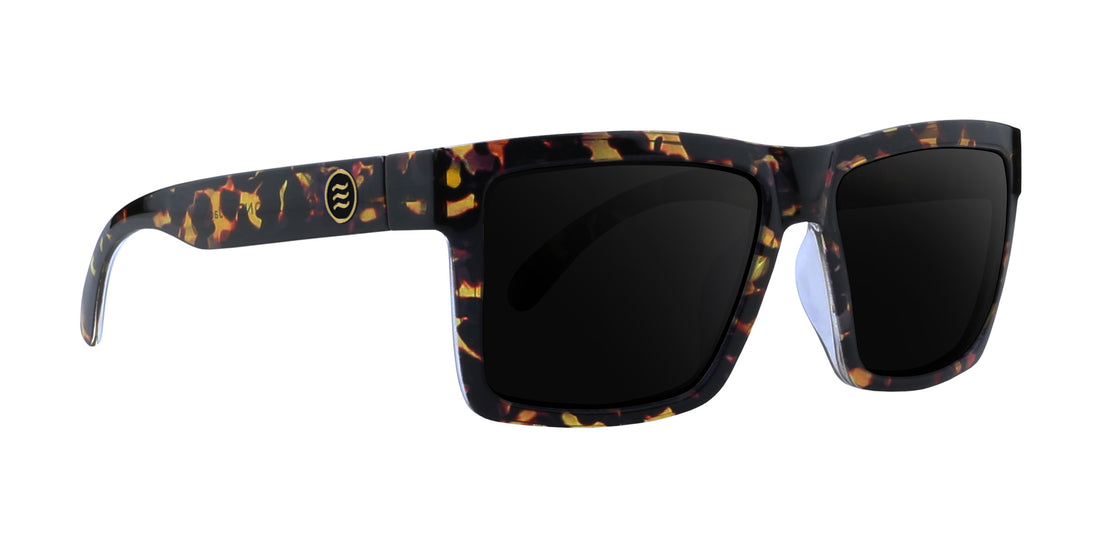 Right-side close-up of Jaguar prescription sunglasses with glossy tortoise-shell frame, black lenses, and gold temple logo