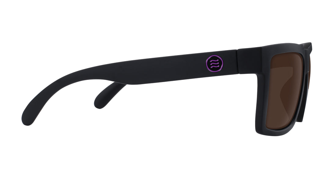 Side view of Nightshade prescription sunglasses showcasing matte black large frame, purple temple logo, and brown lenses on white background