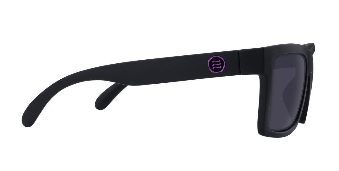 Close up side view of Nightshade sunglasses with matte black frame, purple temple logo and dark lenses on white background