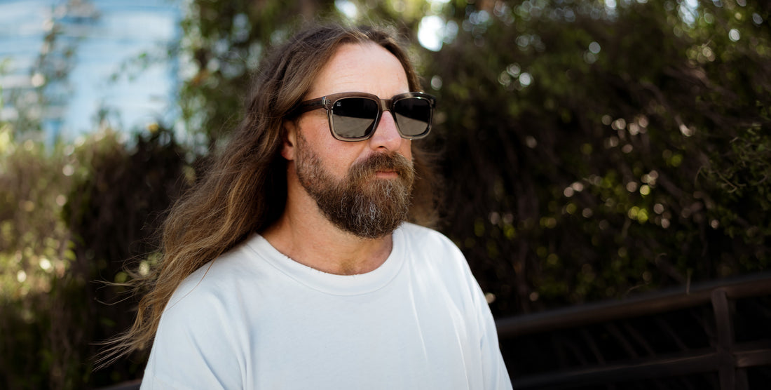 Front view of Buena Creek polarized sunglasses showcasing rectangular gray frames on a model outdoors