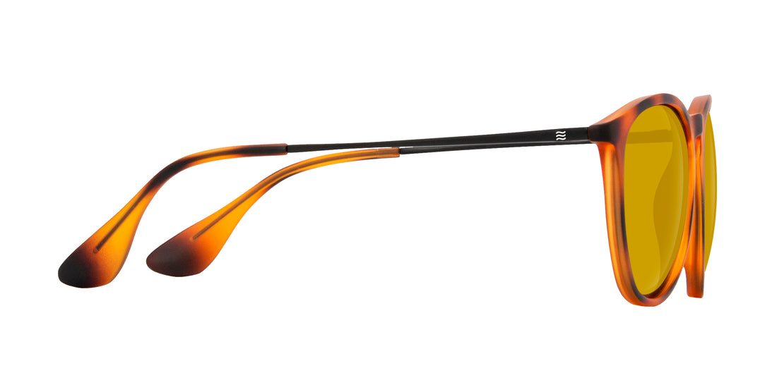 Side view of Bowie prescription sunglasses showcasing tortoise frame, thin black metal temples, and amber yellow lenses on white background
