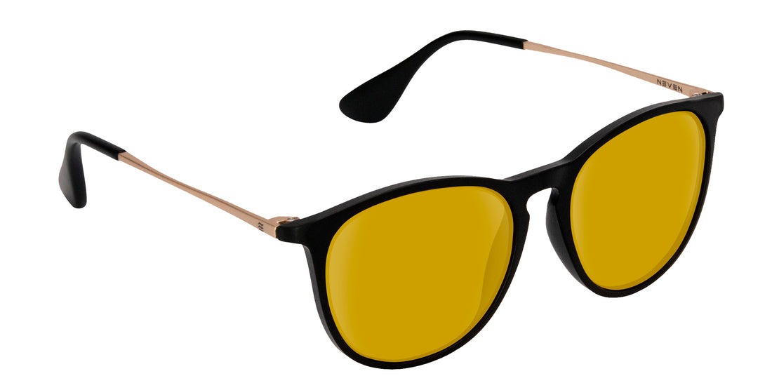 Angled close-up of Goldie Lux prescription sunglasses showcasing yellow lenses, black matte frame, and gold temples on white background