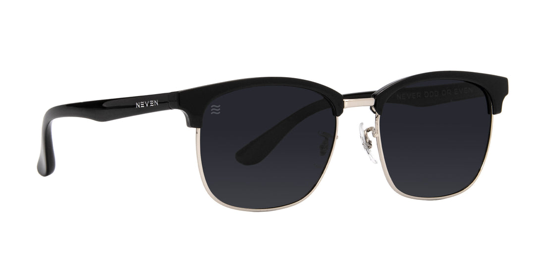 Three-quarter view of Bullet black semi-rimless sunglasses showcasing gold metal lower rims and polarized dark lenses on a white background