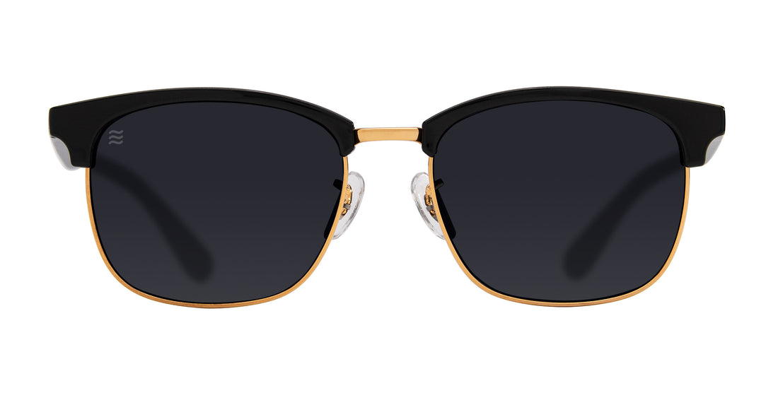 Front of Gold Rush sunglasses with black gloss upper frame, gold rims and black polarized lenses on white background