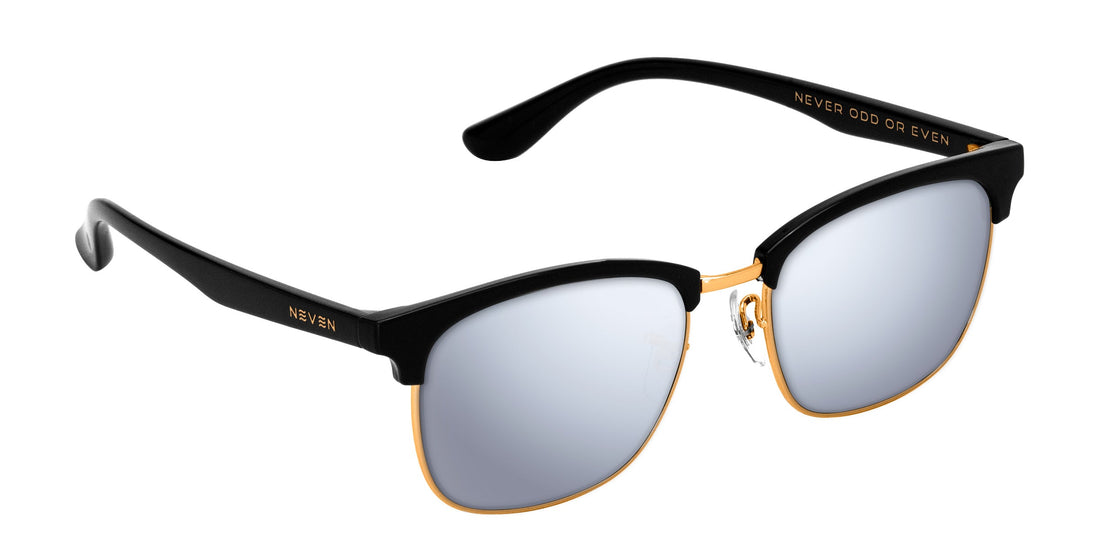 Close up of Gold Rush prescription sunglasses showing silver mirrored lenses, black upper frame and gold trim on white background