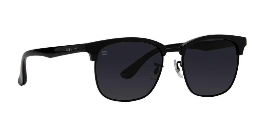Angled front view of Highland Stealth sunglasses with matte black frames, polarized lenses on white background