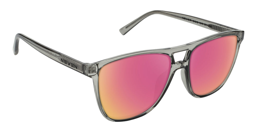 Three-quarter view of Rip Tide prescription sunglasses showcasing translucent cool gray frame and pink mirrored lenses on white background