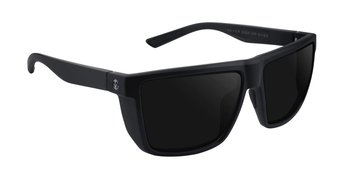 Three-quarter view of Honey Hole sunglasses showcasing matte black frame, dark prescription lenses, and engraved temple reading NEVER ODD OR EVEN on white background