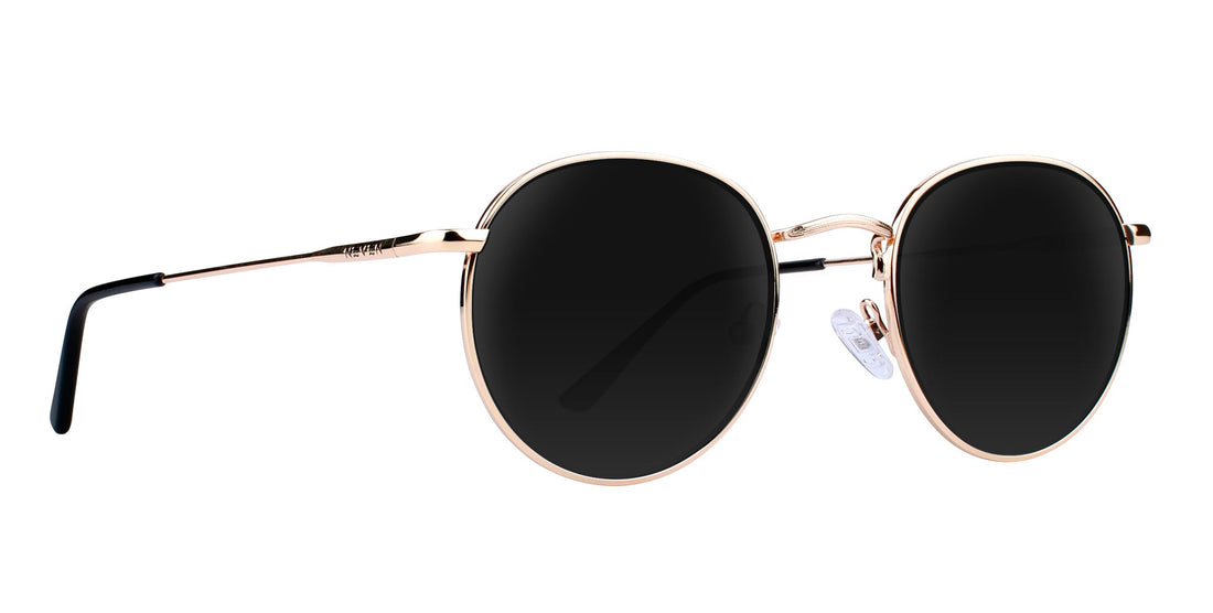 Side view of Rae prescription sunglasses showing rose gold round metal frames, black lenses, and nose pads on white