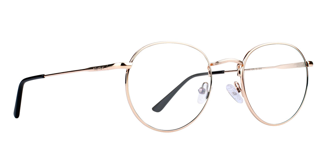 Close-up side view of Rae glasses showing gold round metal frames, clear lenses, and black temple tips on white background
