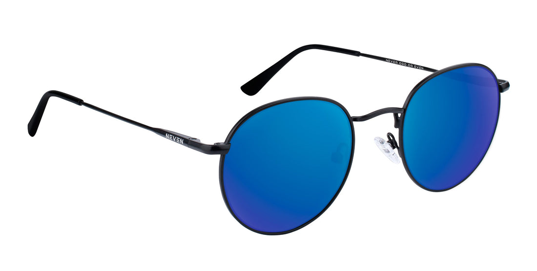 Three-quarter close-up of Saint sunglasses showing thin black aviator frame and blue mirrored prescription lenses on white background