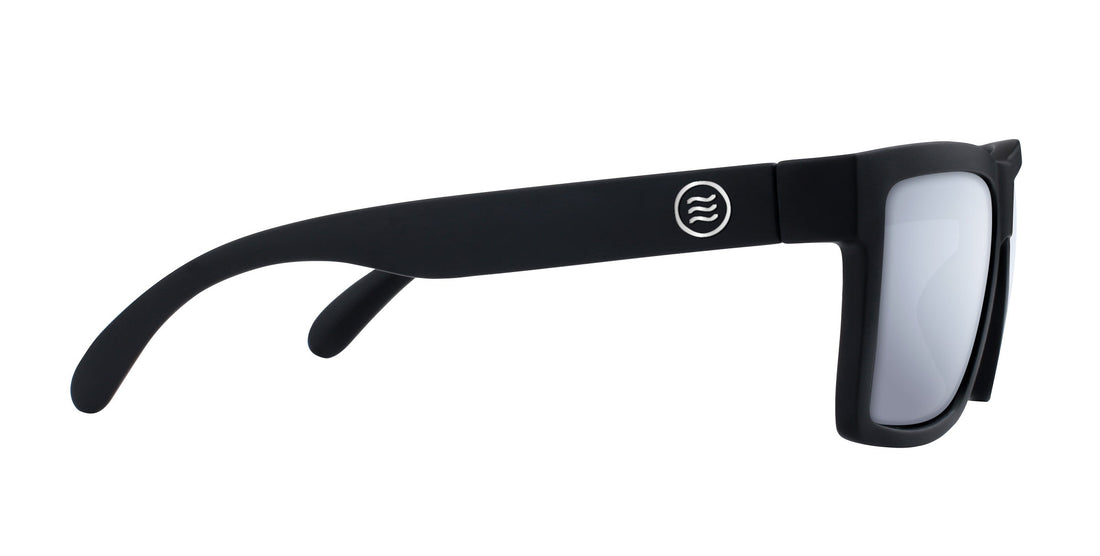 Side view of Lowrider prescription sunglasses showing matte black rectangular frame and circular metal logo on white background